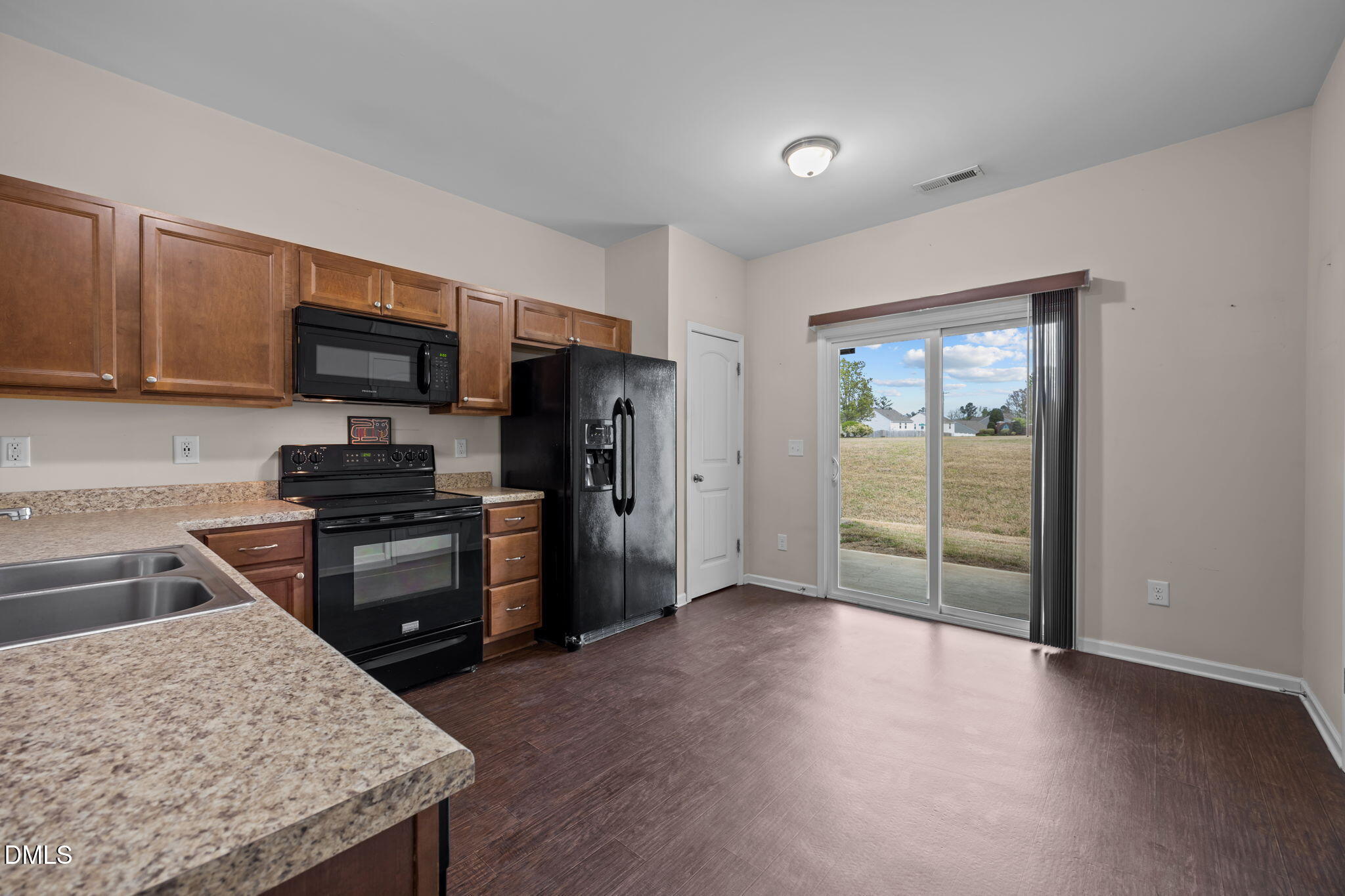 504 Winston Way Creedmoor, NC 27522 - Photo 19 of 45 a kitchen with granite countertop a refrigerator stove and sink