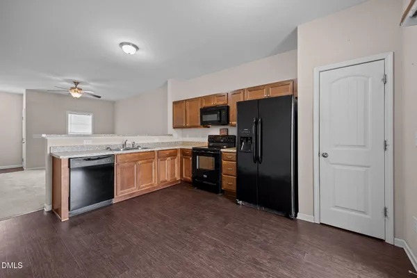 a kitchen with a refrigerator and a sink
