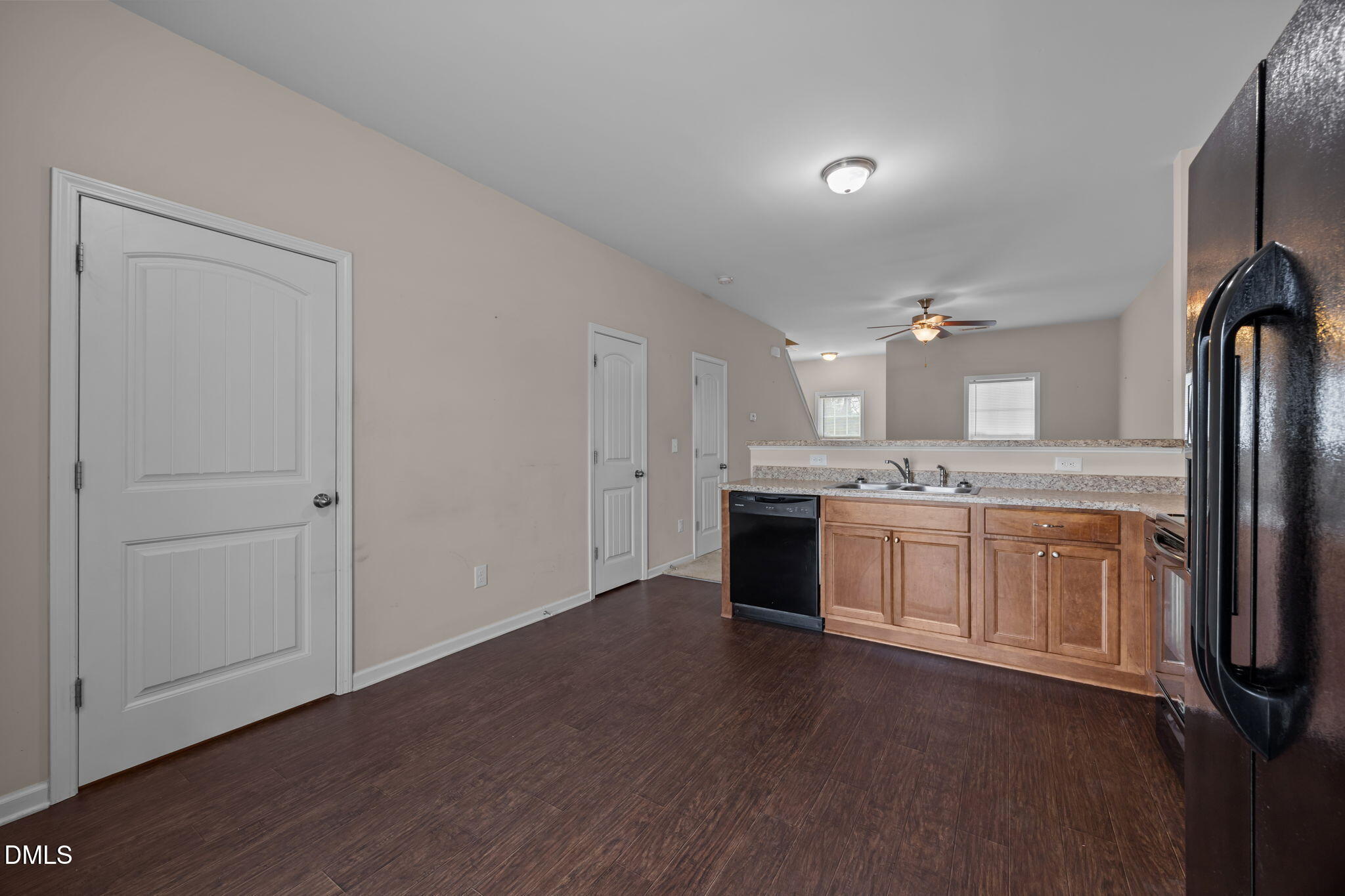 504 Winston Way Creedmoor, NC 27522 - Photo 21 of 45 a large white kitchen with a sink dishwasher a stove and a refrigerator with wooden floor