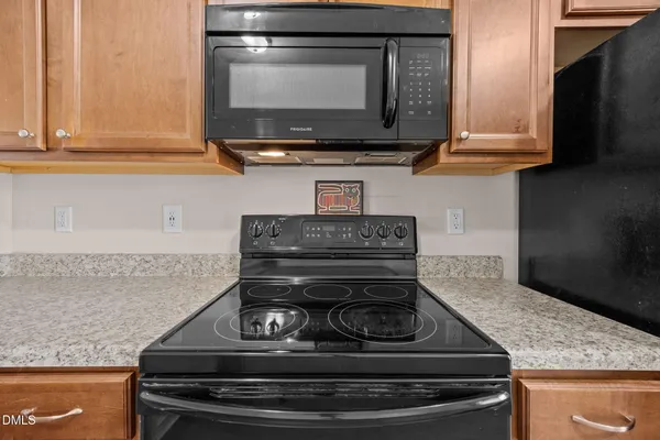 a stove top oven sitting inside of a kitchen