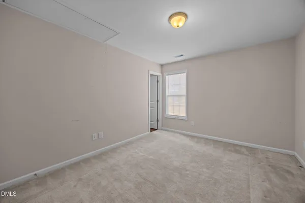 an empty room with a empty space and a window