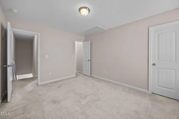 an empty room with closet area