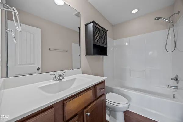 a bathroom with a sink toilet tub and shower