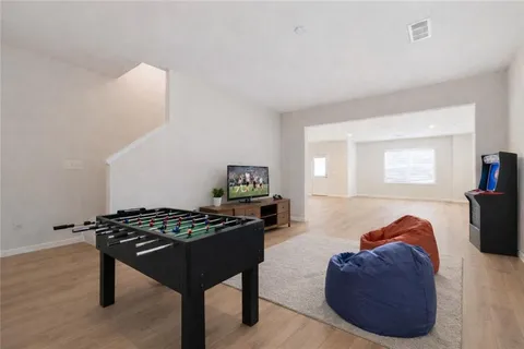 a bedroom with furniture and a wooden floor