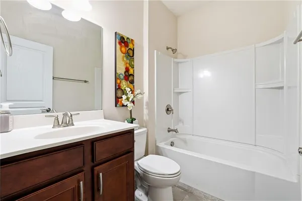 a bathroom with a sink toilet tub and shower