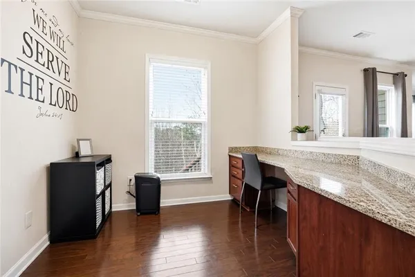 a view of kitchen with granite countertop window and wooden floor
