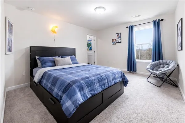 a spacious bedroom with a bed and a couch