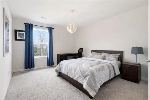 a bedroom with a bed and a night stand