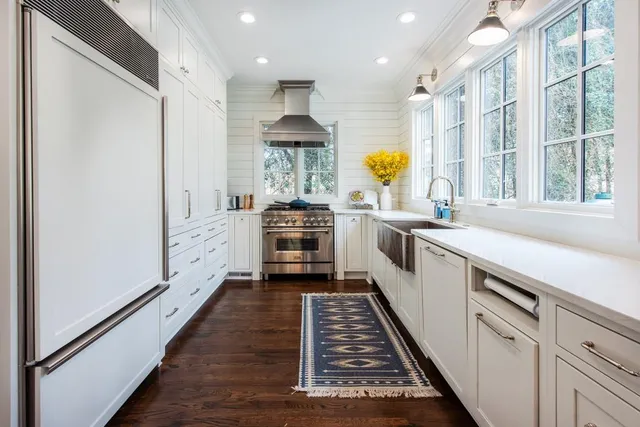 a kitchen with stainless steel appliances a sink and cabinets