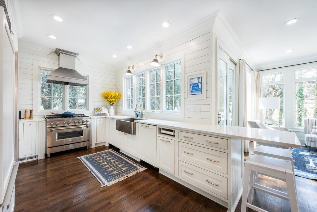 3211 Circle Oaks Drive Southeast Atlanta, GA 30339 - Photo 16 of 50 a kitchen with stainless steel appliances a stove a sink and white cabinets with wooden floor