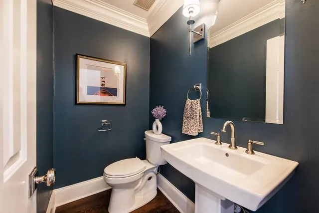 a bathroom with a sink mirror and toilet