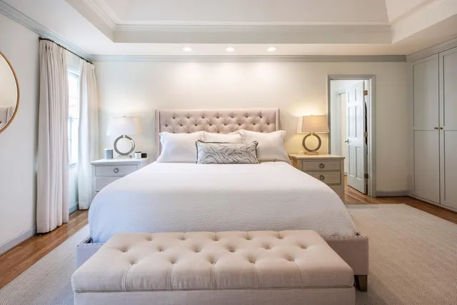 a bedroom with a bed and a mirror