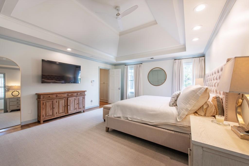3211 Circle Oaks Drive Southeast Atlanta, GA 30339 - Photo 26 of 50 a bedroom with a bed and flat tv screen on the dresser