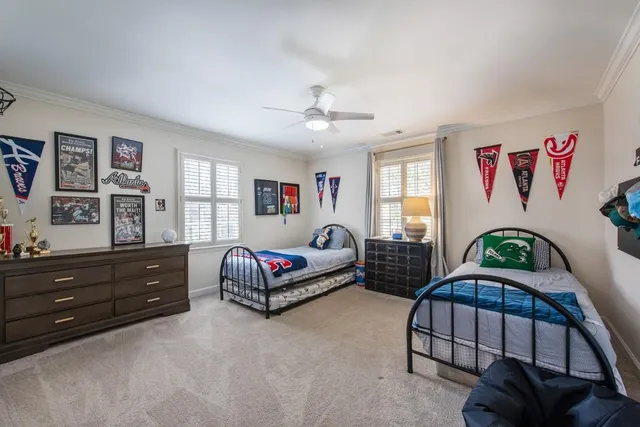 a bedroom with two beds and a window