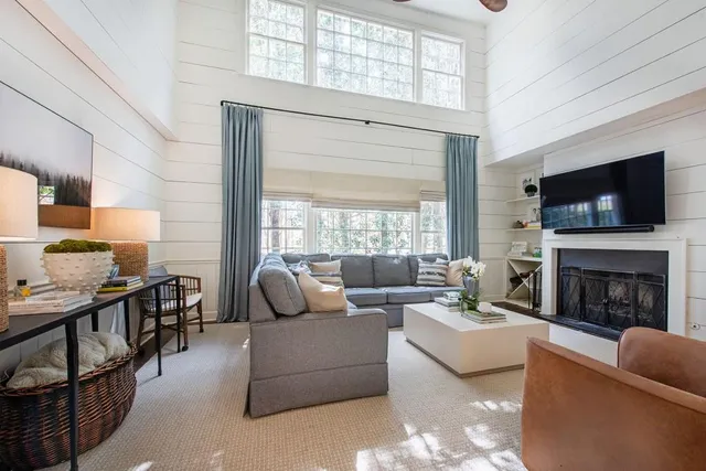 a living room with furniture fireplace and flat screen tv