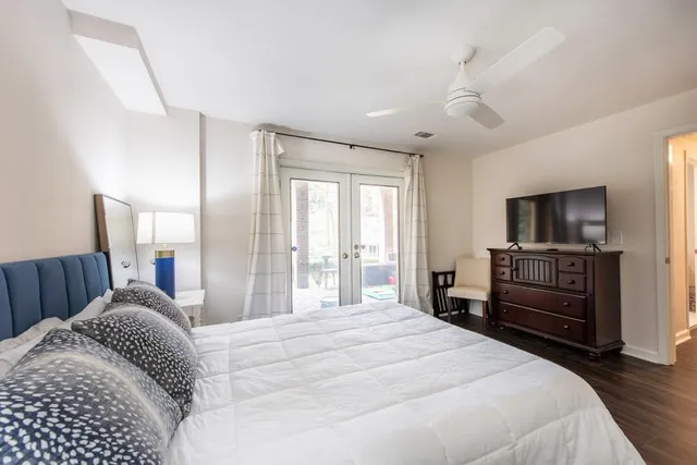 a bedroom with a bed and a flat screen tv