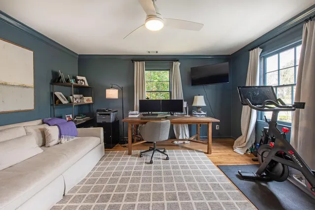 a living room with furniture a window and gym equipment