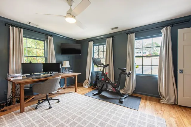 a view of a workspace with furniture and a window