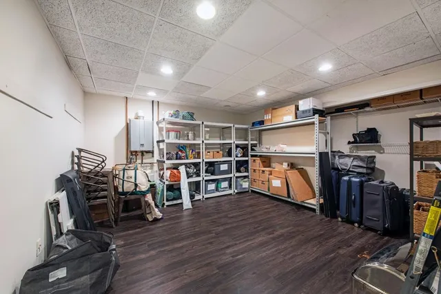a view of a room with lots of wooden furniture and windows