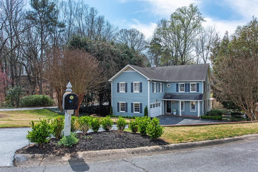 3211 Circle Oaks Drive Southeast Atlanta, GA 30339 - Photo 50 of 50 a front view of a house with a yard and garage