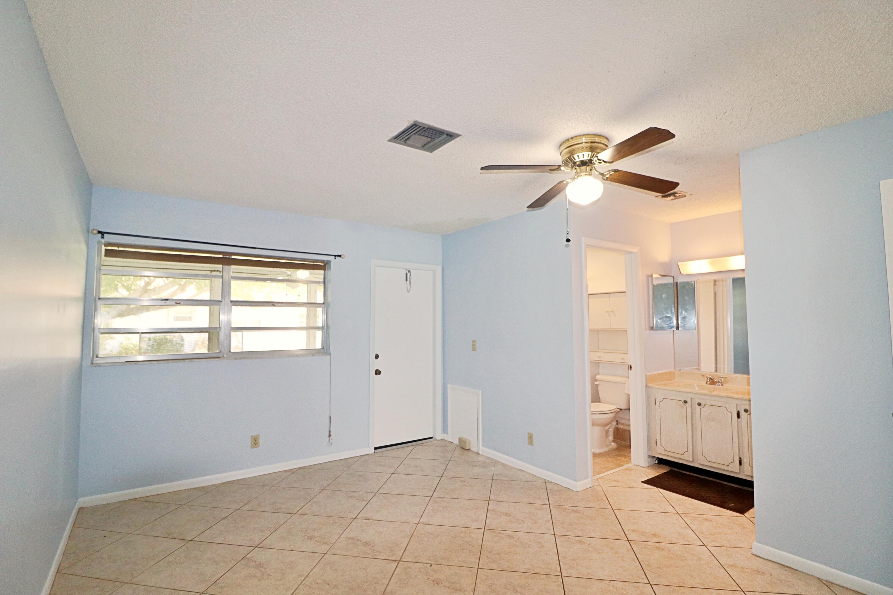 831 Timberview Drive, Unit C Fort Pierce, FL 34982 - Photo 11 of 18 a view of an empty room with a window