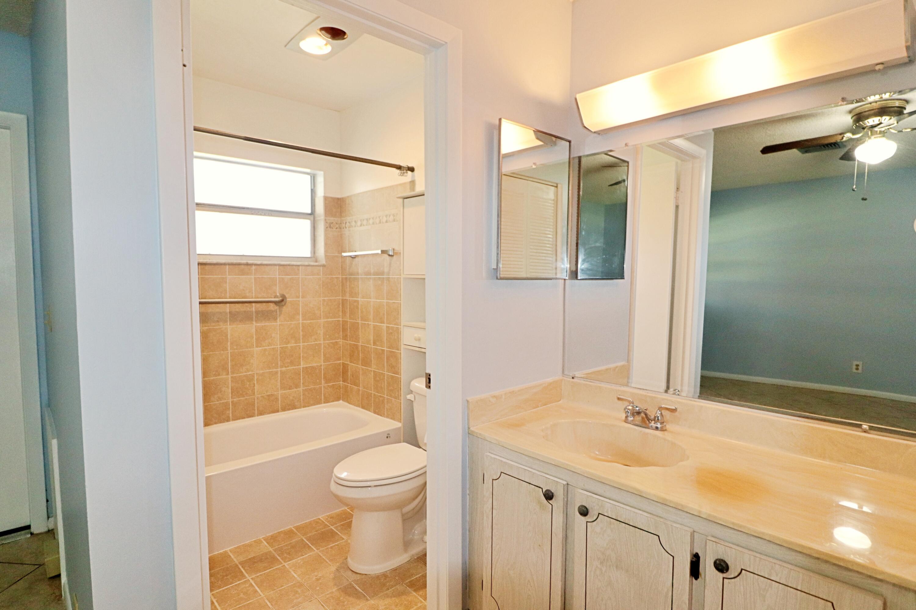 831 Timberview Drive, Unit C Fort Pierce, FL 34982 - Photo 13 of 18 a bathroom with a sink toilet and shower
