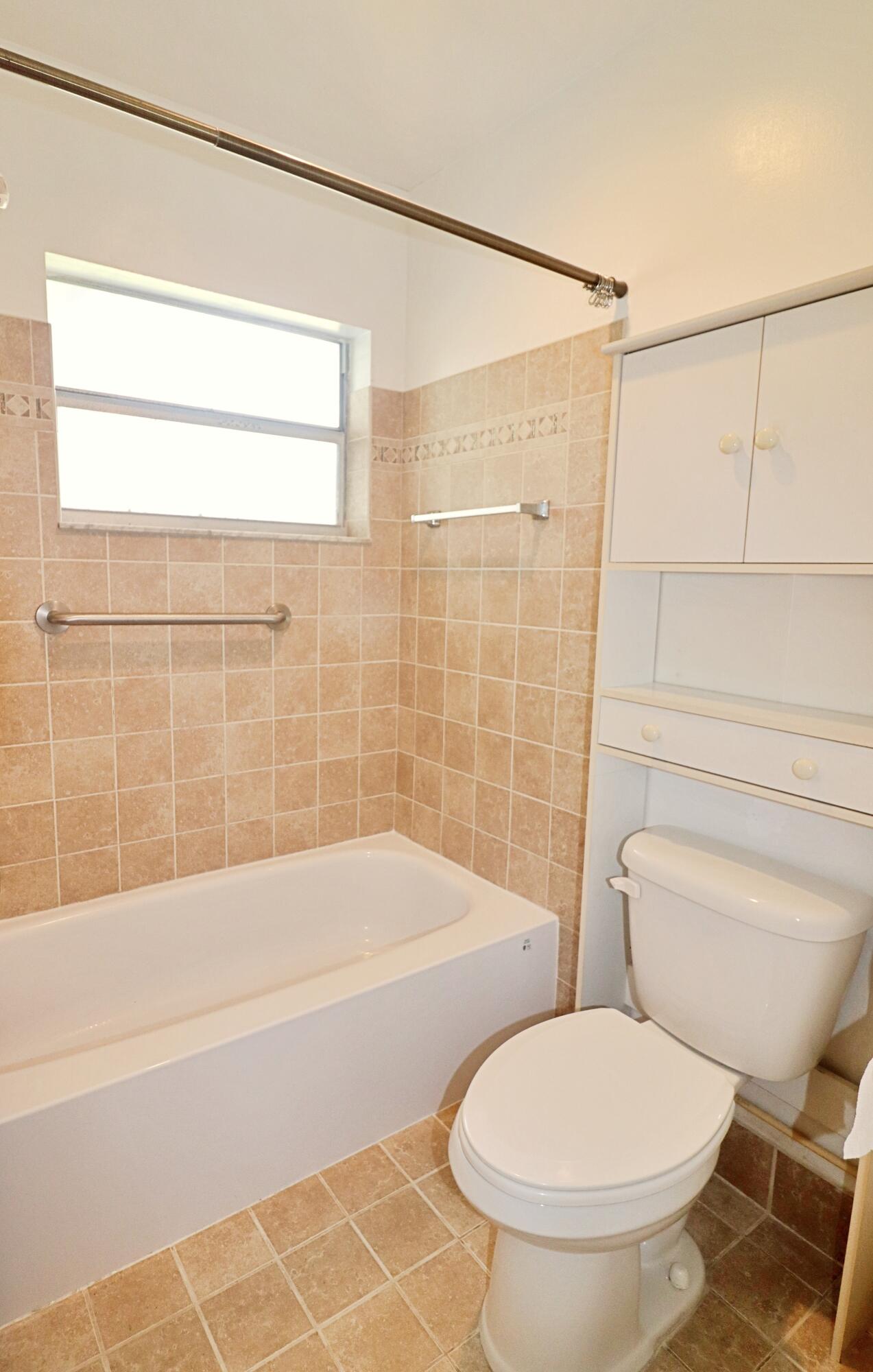 831 Timberview Drive, Unit C Fort Pierce, FL 34982 - Photo 14 of 18 a bathroom with a toilet and a bathtub