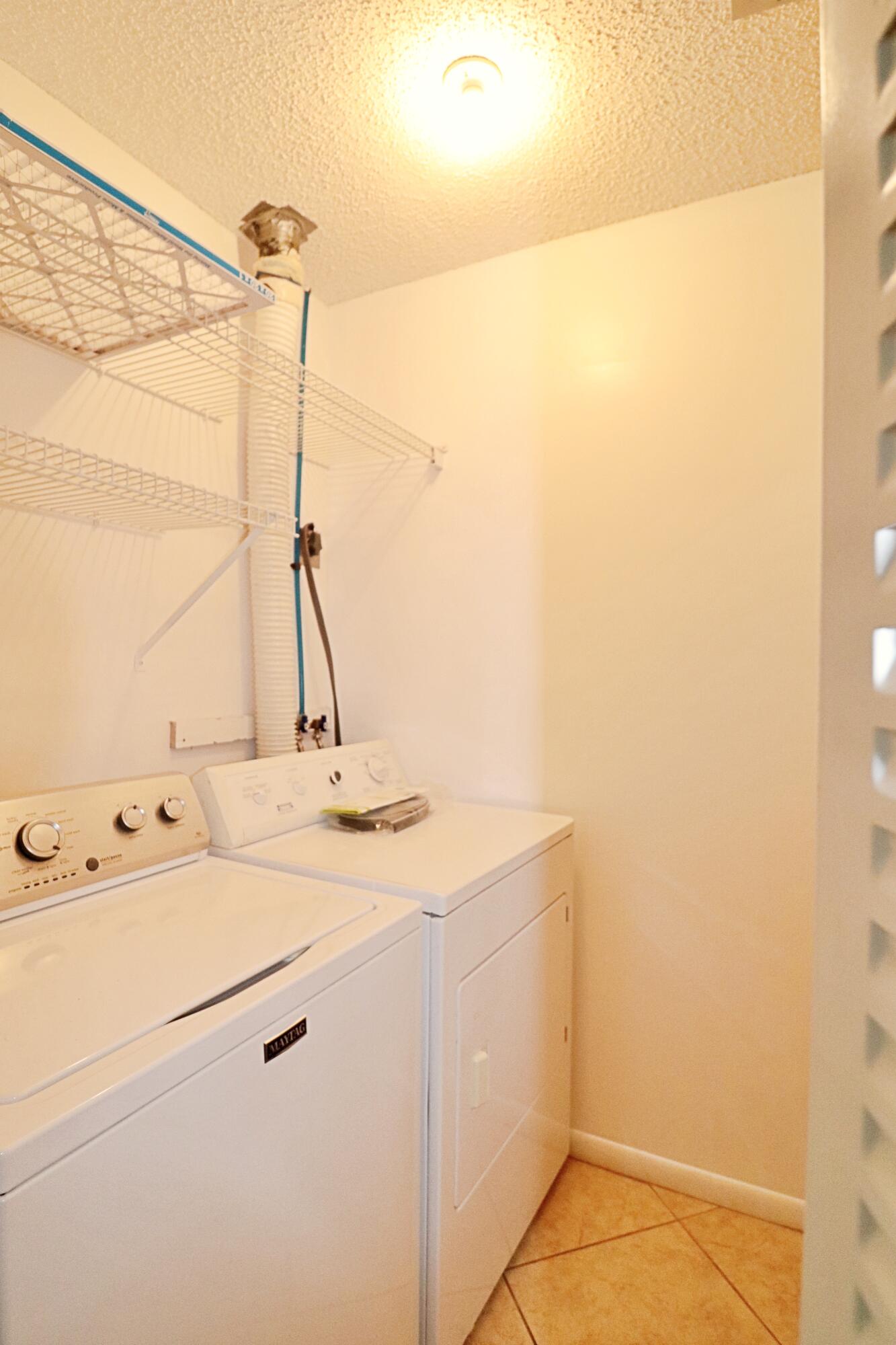 831 Timberview Drive, Unit C Fort Pierce, FL 34982 - Photo 15 of 18 a utility room with dryer and washer