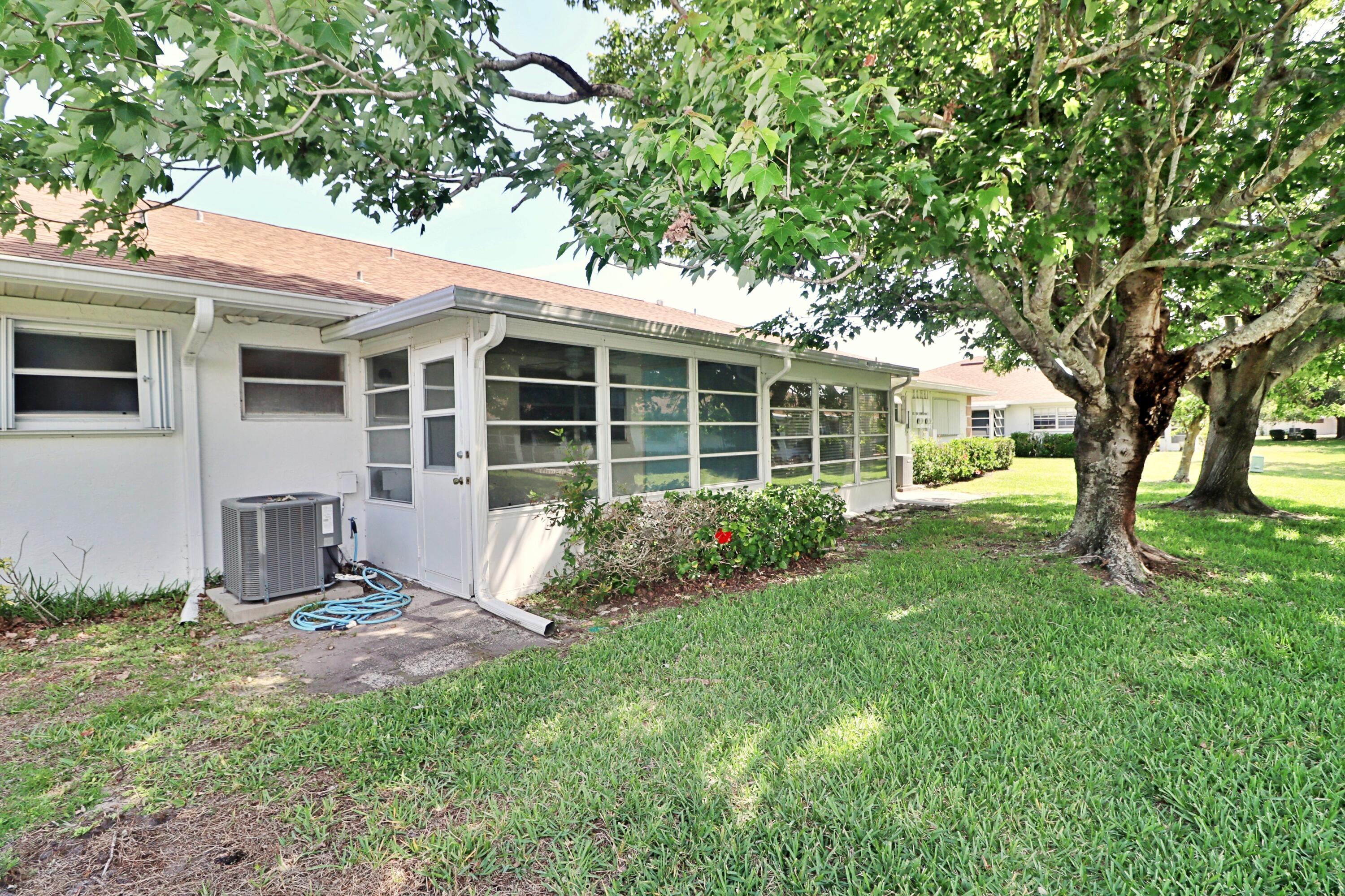 831 Timberview Drive, Unit C Fort Pierce, FL 34982 - Photo 18 of 18 a view of a house with backyard and a tree
