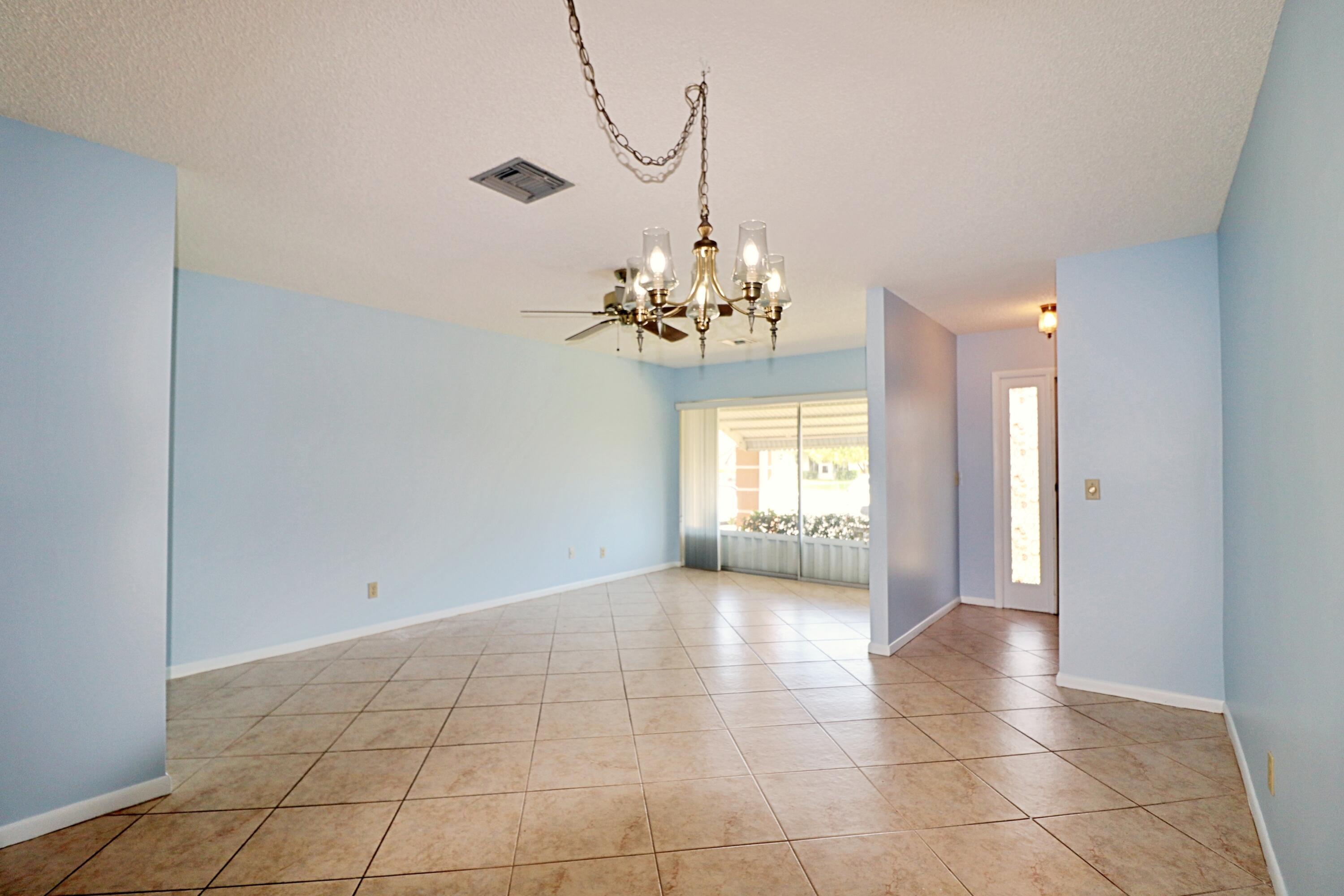 831 Timberview Drive, Unit C Fort Pierce, FL 34982 - Photo 4 of 18 a view of a chandelier in big room and chandelier