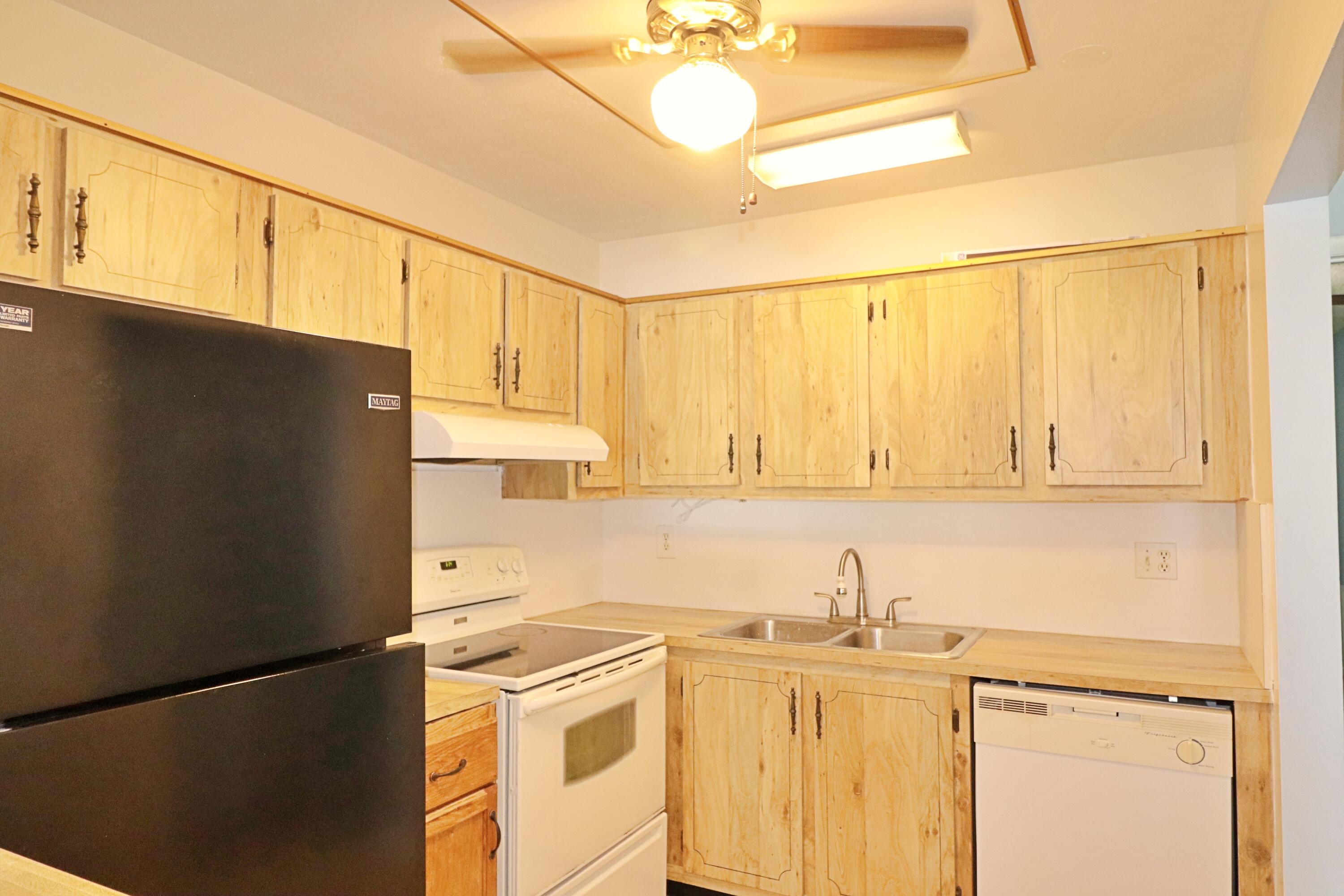 831 Timberview Drive, Unit C Fort Pierce, FL 34982 - Photo 6 of 18 a kitchen with stainless steel appliances granite countertop a refrigerator a stove and a sink