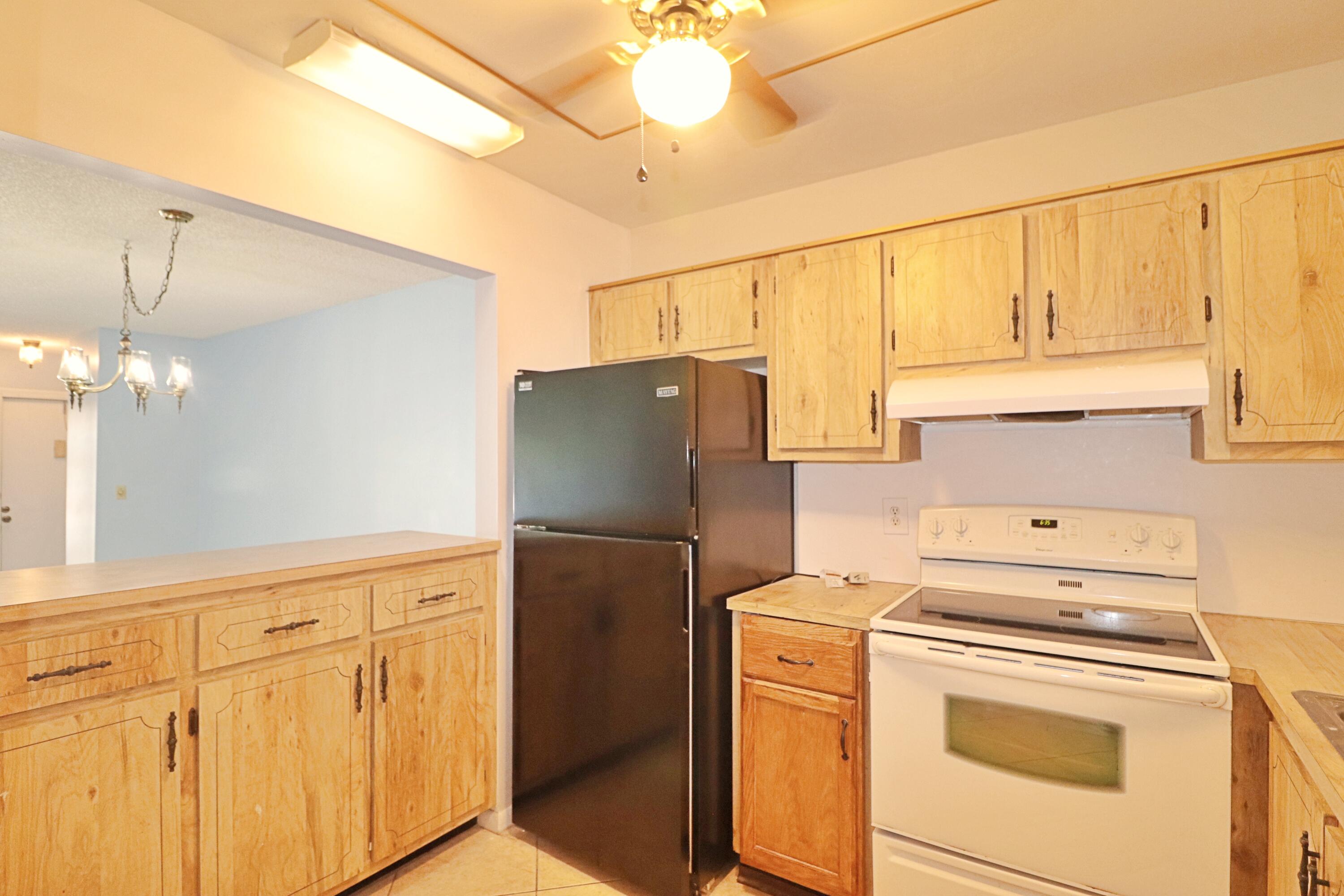 831 Timberview Drive, Unit C Fort Pierce, FL 34982 - Photo 7 of 18 a kitchen with appliances cabinets and a window