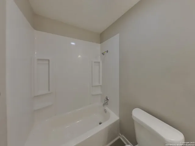 a bathroom with a bathtub and toilet