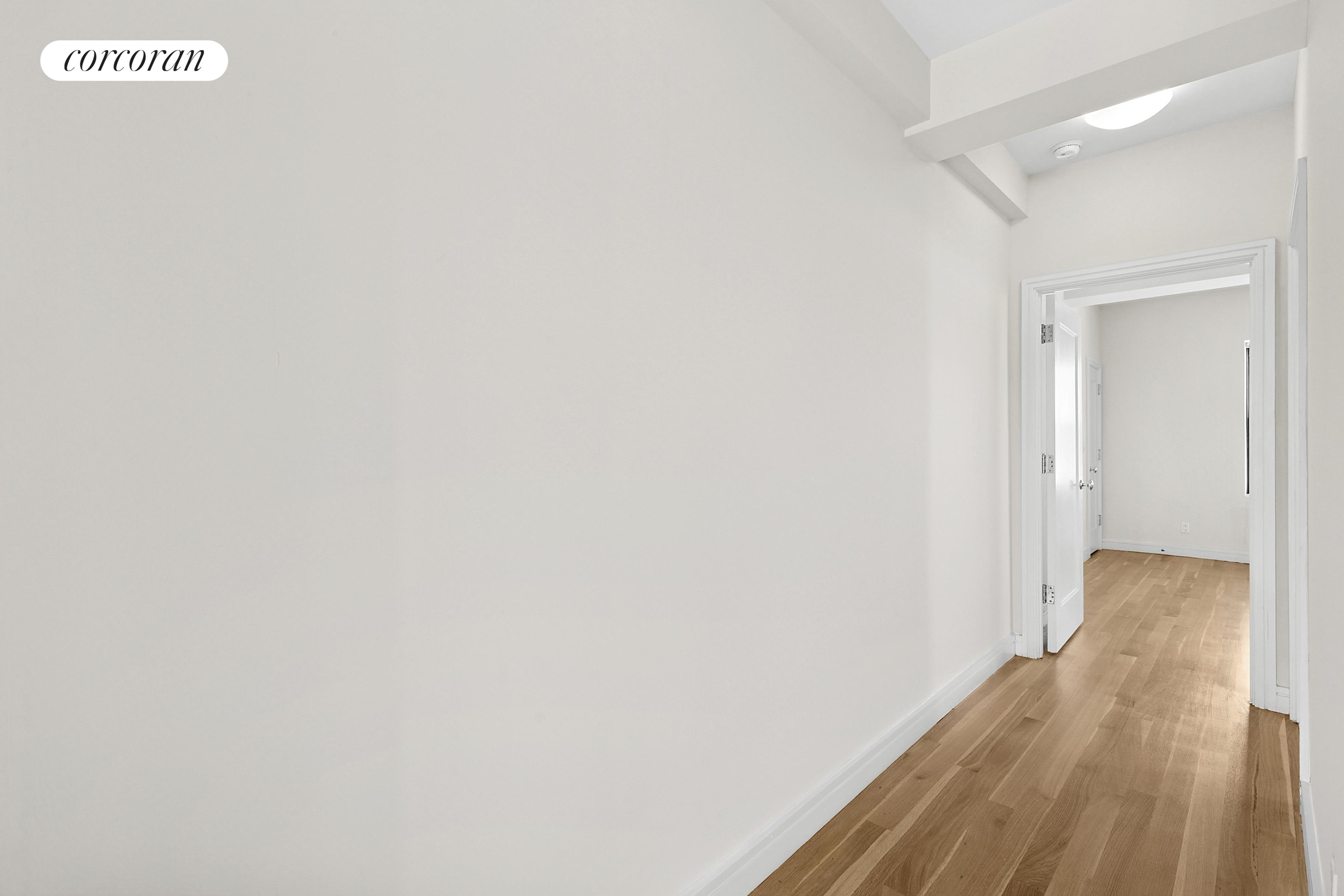 230 Riverside Drive, Unit 19L Manhattan, NY 10025 - Photo 13 of 18 a view of a hallway with wooden floor