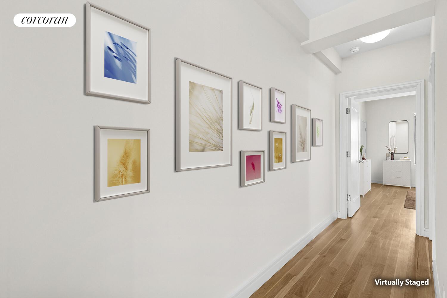 230 Riverside Drive, Unit 19L Manhattan, NY 10025 - Photo 3 of 18 a hallway with painting on the wall and a wooden floor