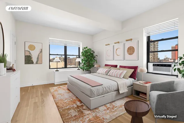 a hallway with painting on the wall and a wooden floor