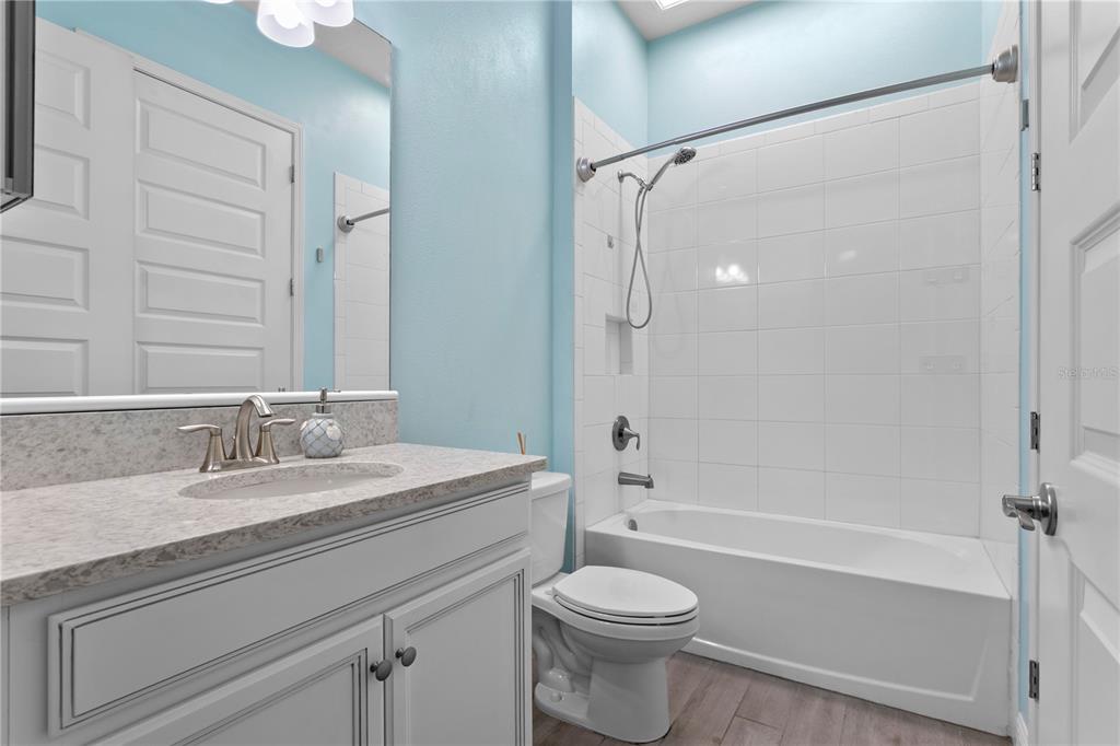 493 Nowell Loop DeLand, FL 32724 - Photo 12 of 33 a bathroom with a granite countertop sink toilet and shower