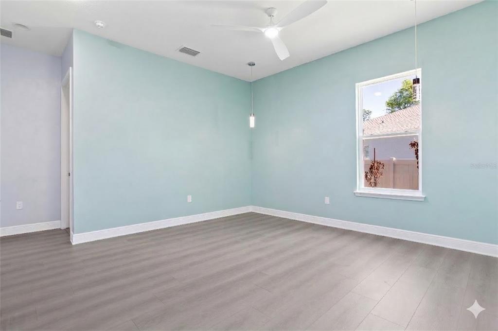 493 Nowell Loop DeLand, FL 32724 - Photo 19 of 33 an empty room with wooden floor and window