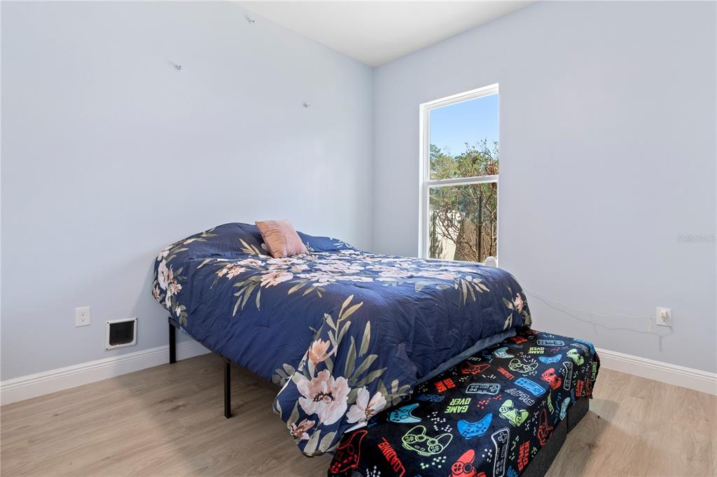 493 Nowell Loop DeLand, FL 32724 - Photo 20 of 33 a bedroom with a bed and a window