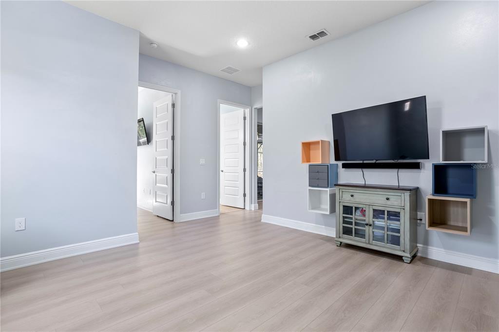 493 Nowell Loop DeLand, FL 32724 - Photo 22 of 33 a view of a livingroom with furniture and a flat screen tv