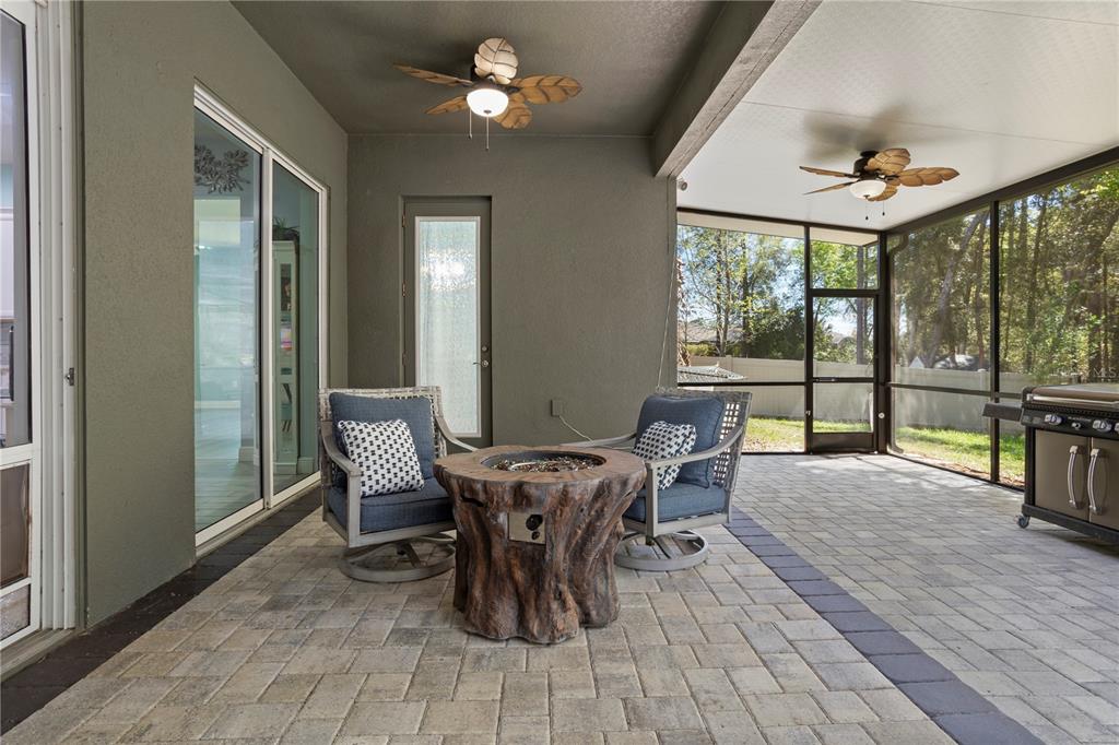 493 Nowell Loop DeLand, FL 32724 - Photo 26 of 33 a view of a dining room with furniture large windows and wooden floor