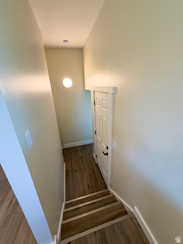 450 13800 South, Unit 2 Draper, UT 84020 - Photo 16 of 21 Stairwell with wood-finish flooring, white trim, and a contemporary wall-mounted light fixture