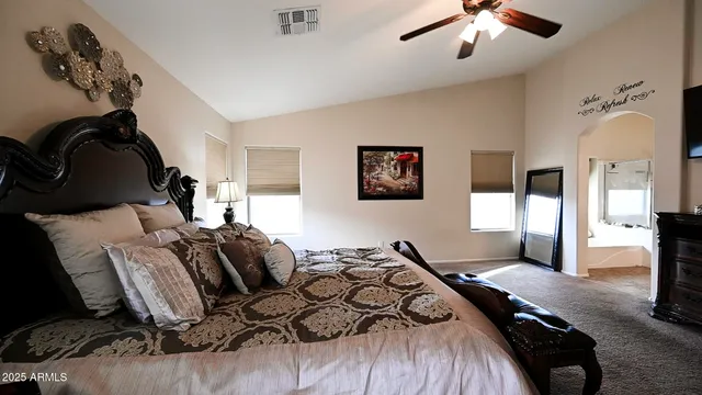 a bedroom with a bed and glass walk in closet