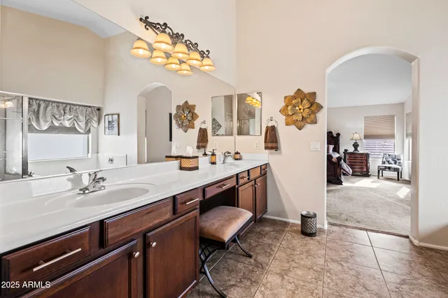a bathroom with a sink a vanity and a mirror