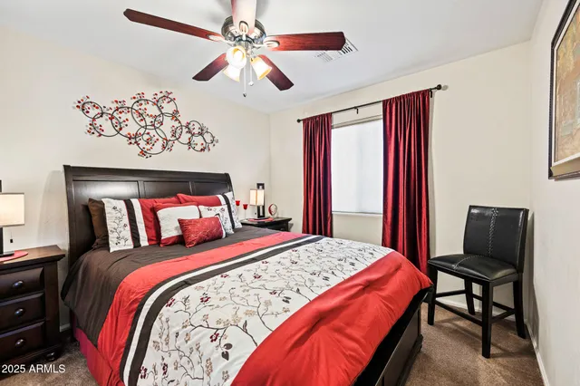 a bedroom with a bed and a chandelier