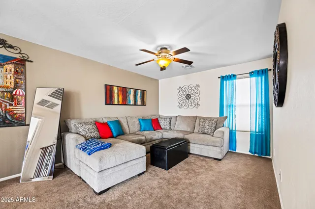a living room with furniture flowerpot and a window