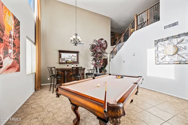 a living room with furniture a table and a chandelier