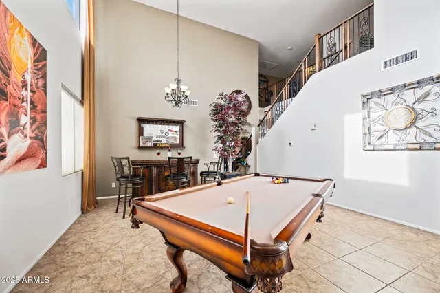 a living room with furniture a table and a chandelier