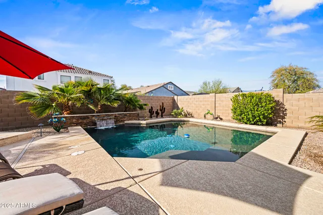 a view of a terrace with wooden floor and a yard