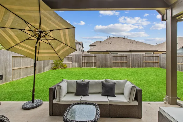 a view of a house with backyard and couches